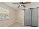 Room with tile floors, barn door, and window at 7852 Murcott Cir, Orlando, FL 32835