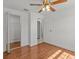 Bedroom with wood flooring, large closet, and ceiling fan at 7852 Murcott Cir, Orlando, FL 32835