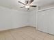 Simple bedroom with tile floors, ceiling fan, and double door closet at 7852 Murcott Cir, Orlando, FL 32835