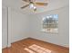 Bright bedroom featuring wood-look floors and ceiling fan at 7852 Murcott Cir, Orlando, FL 32835