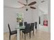 Dining room with glass table and six black chairs at 7852 Murcott Cir, Orlando, FL 32835