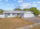 Charming single-story home with a white garage door and landscaped lawn at 7852 Murcott Cir, Orlando, FL 32835