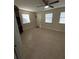 Bright, spacious room with tile flooring, ceiling fan, and window coverings at 7852 Murcott Cir, Orlando, FL 32835