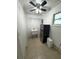 Bright laundry room, features a utility sink, refrigerator, and ample shelving at 7852 Murcott Cir, Orlando, FL 32835