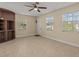 Bright living room with tile floors, built-in shelving, and ceiling fan at 7852 Murcott Cir, Orlando, FL 32835