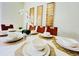 Dining room with white table, brown chairs, and gold wall art at 8902 Sydney Ave, Kissimmee, FL 34747