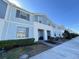 Blue townhome with walkway, landscaping, and street view at 8902 Sydney Ave, Kissimmee, FL 34747