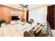 Living room with brown leather couches, TV, and sliding glass doors at 8902 Sydney Ave, Kissimmee, FL 34747