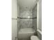 Clean bathroom with tub and marble tile at 8944 Sw 128Th Pl, Ocala, FL 34473