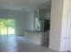 Open concept kitchen with island, stainless steel appliances, and grey tile floors at 8944 Sw 128Th Pl, Ocala, FL 34473