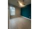 Bedroom with teal accent wall and ceiling fan at 922 Umbria Dr, Poinciana, FL 34759