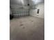 Empty two car garage featuring an overhead door and concrete flooring at 922 Umbria Dr, Poinciana, FL 34759