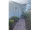 Brick walkway leading to the house entrance, bordered by lush greenery at 922 Umbria Dr, Poinciana, FL 34759