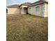 Tan house with white garage door and columns at 975 Gascony Ct, Kissimmee, FL 34759