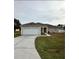 Tan house with white garage door and columns at 975 Gascony Ct, Kissimmee, FL 34759