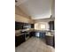 Kitchen with dark brown cabinets and stainless steel appliances at 975 Gascony Ct, Kissimmee, FL 34759