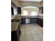 Spacious kitchen with stainless steel appliances and dark wood cabinets at 975 Gascony Ct, Kissimmee, FL 34759