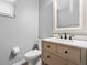 Modern bathroom with light wood vanity and a large mirror at 9856 Heron Pointe Dr, Orlando, FL 32832