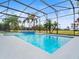 Inviting screened pool with tiled spa and tranquil golf course views at 9856 Heron Pointe Dr, Orlando, FL 32832