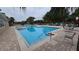 Relaxing community swimming pool with lounge chairs at 9856 Heron Pointe Dr, Orlando, FL 32832