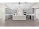 Modern kitchen with gray cabinets, quartz countertops, and an island at Tbd Sw 93 St, Dunnellon, FL 34432