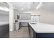 Modern kitchen with gray cabinets, white quartz countertops and a farmhouse sink at Tbd Sw 93 St, Dunnellon, FL 34432