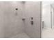 Large walk-in shower with gray tile and built-in shelf at Tbd Sw 93 St, Dunnellon, FL 34432