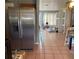 View of kitchen with stainless steel refrigerator and tiled floor at 102 San Blas Ave, Kissimmee, FL 34743