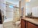 Clean bathroom with tub, shower, granite vanity, and updated fixtures at 107 Cupania Ct, Groveland, FL 34736