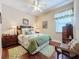 Well-lit bedroom with a queen-size bed, wood floors, and ample closet space at 107 Cupania Ct, Groveland, FL 34736