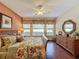 Main bedroom with wood floors and a ceiling fan at 107 Cupania Ct, Groveland, FL 34736