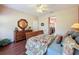 Main bedroom with ensuite bathroom access and wood floors at 107 Cupania Ct, Groveland, FL 34736