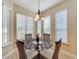 Bright breakfast nook with glass table and wicker chairs at 107 Cupania Ct, Groveland, FL 34736