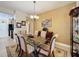 Elegant dining room featuring a glass-top table and hardwood floors at 107 Cupania Ct, Groveland, FL 34736