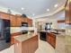 Spacious kitchen with island, granite countertops and stainless steel appliances at 107 Cupania Ct, Groveland, FL 34736