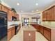 Spacious kitchen with island, granite countertops, and stainless steel appliances at 107 Cupania Ct, Groveland, FL 34736