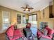 Cozy sunroom featuring a fireplace, wicker furniture, and tiled floors at 107 Cupania Ct, Groveland, FL 34736