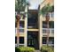 Exterior view of condo building with stairs and palm trees at 1071 S Hiawassee Rd # 1213, Orlando, FL 32835