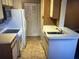 Small kitchen with white appliances and light wood cabinets at 1071 S Hiawassee Rd # 1213, Orlando, FL 32835