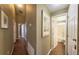 Long hallway with wood floors and access to bathroom at 1138 Mariner Cay Dr, Haines City, FL 33844