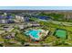 Aerial view of community pool, tennis courts, pond, and clubhouse; a resort-style amenity at 11526 Comic Aly, Orlando, FL 32832
