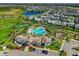 Beautiful aerial view showcasing a resort-style community with pool, tennis courts, and lush landscaping at 11526 Comic Aly, Orlando, FL 32832