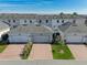 A beautiful aerial view showcasing the community townhomes, driveways, and the well-maintained landscaping at 11526 Comic Aly, Orlando, FL 32832