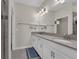 Double vanity bathroom with gray countertop and modern lighting at 11526 Comic Aly, Orlando, FL 32832