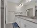 Primary bathroom featuring dual sinks, gray counters, white cabinets, and brushed nickel fixtures at 11526 Comic Aly, Orlando, FL 32832