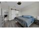 Primary bedroom with barn door to en-suite bathroom and gray flooring at 11526 Comic Aly, Orlando, FL 32832