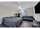 Spacious bedroom with a ceiling fan, wood flooring, a large window, and comfortable seating at 11526 Comic Aly, Orlando, FL 32832
