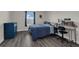 Comfortable bedroom with a large window, desk, dresser and gray laminate flooring at 11526 Comic Aly, Orlando, FL 32832