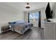 Bedroom features hardwood floors, a large window, a ceiling fan, and neutral-colored walls creating a cozy ambiance at 11526 Comic Aly, Orlando, FL 32832