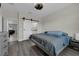 Bedroom featuring hard wood floors, a large window with natural light, and a barn door to the bathroom at 11526 Comic Aly, Orlando, FL 32832